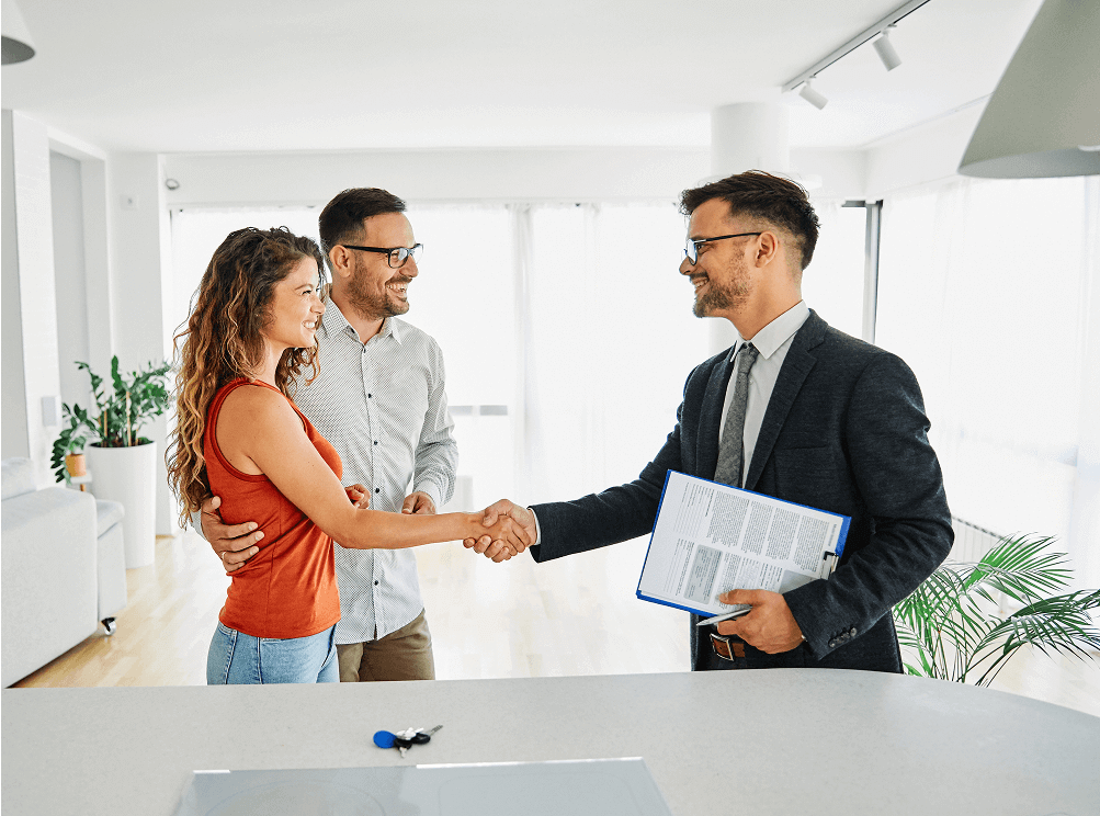 Smiling buyers greet agent holding contract