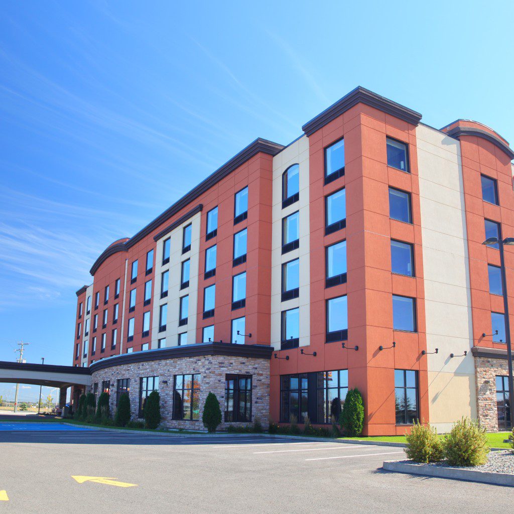 Modern hotel building under clear blue sky.