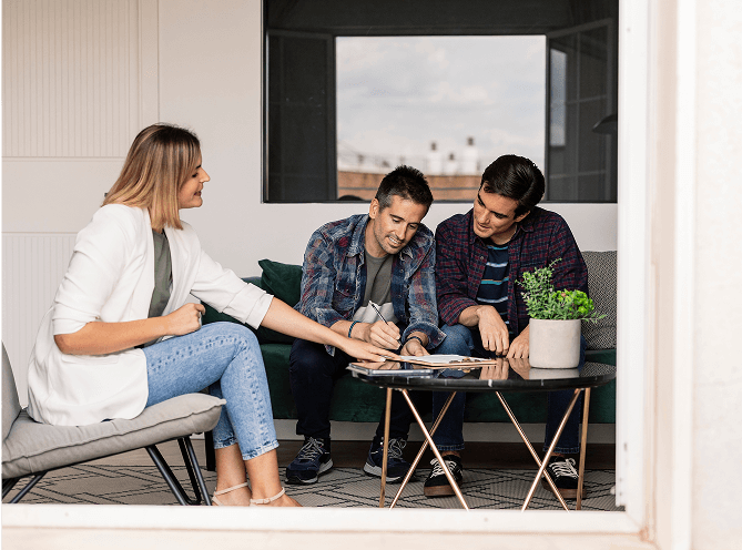 People collaborating at a small indoor table.