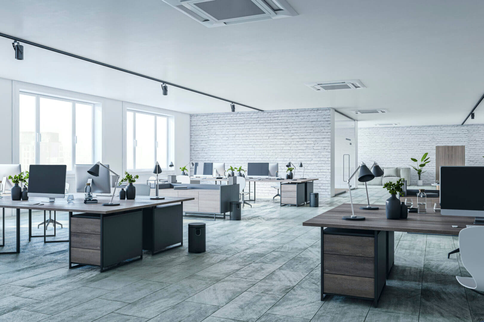 Modern open-plan office with desks and computers.