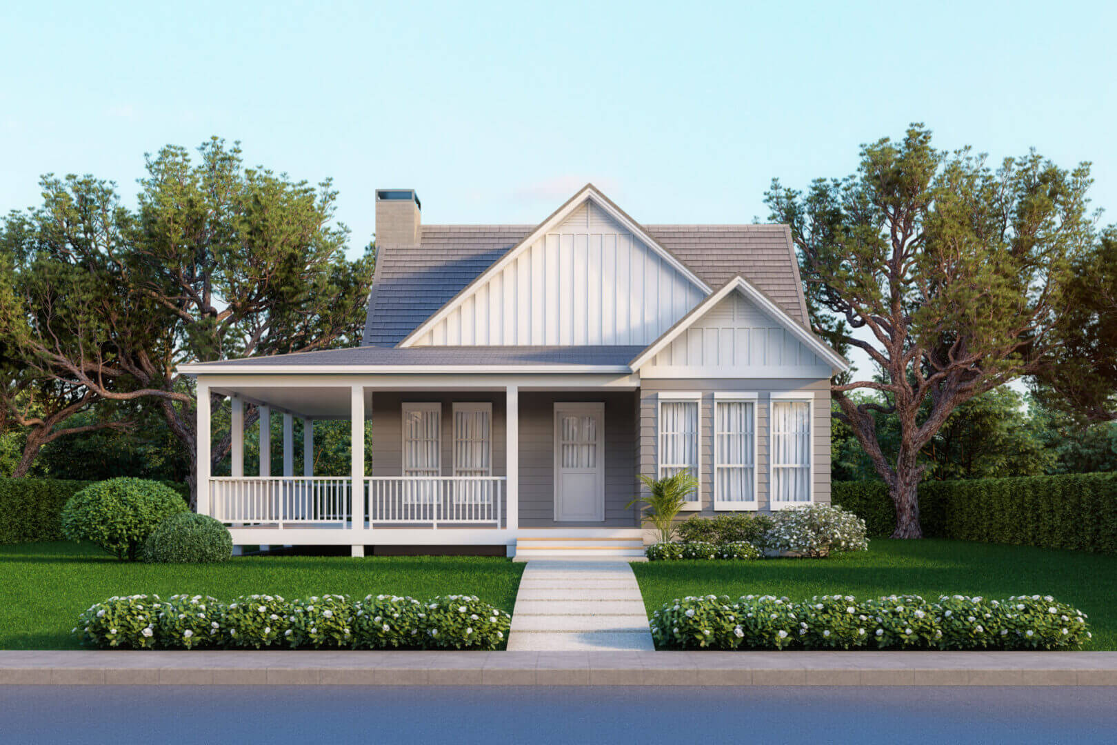 A charming white farmhouse with a spacious front porch and lush greenery.
